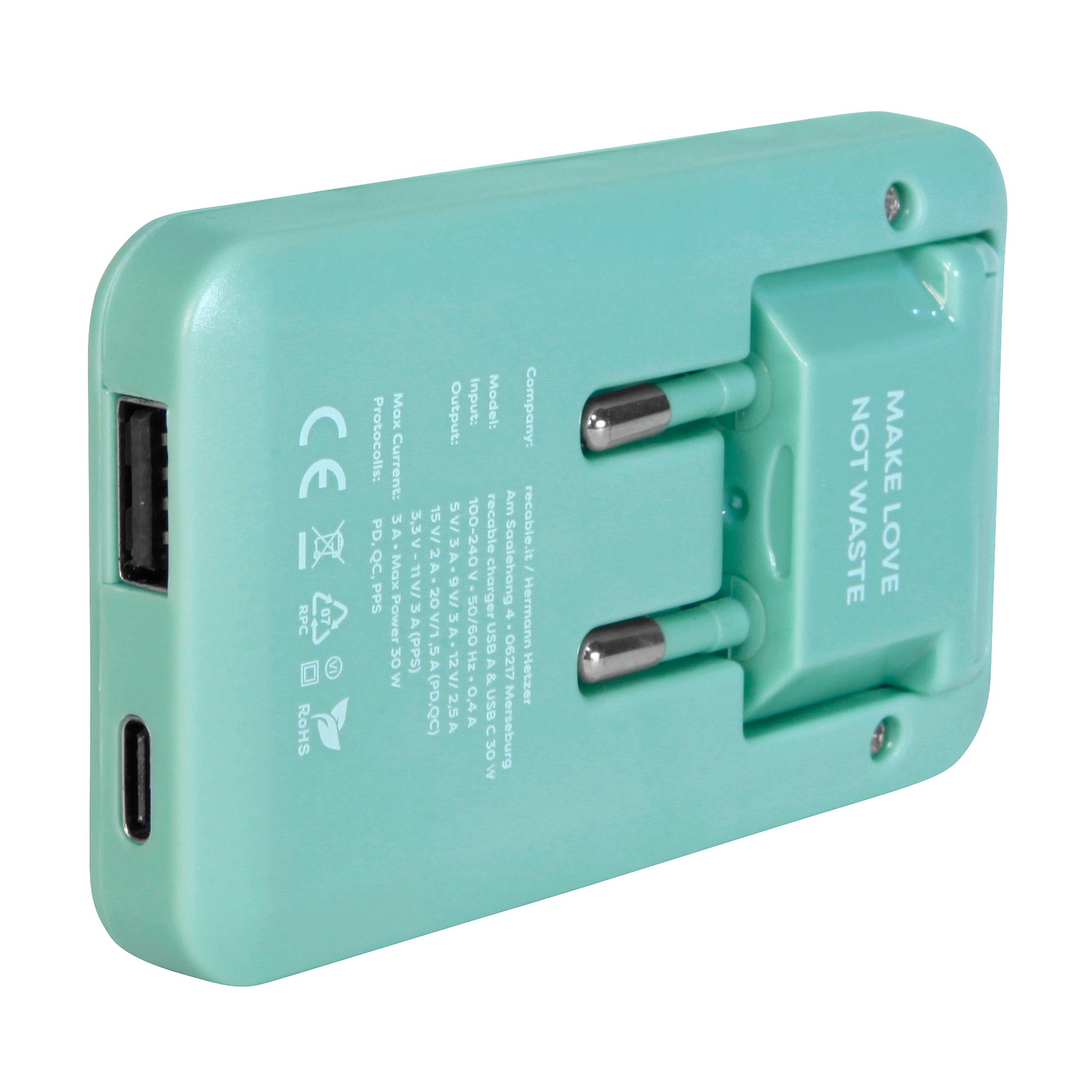 The pastel green charger lies in a side position. A USB-A port and a USB-C port are also visible.